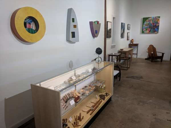 art studio with paintings and a display case